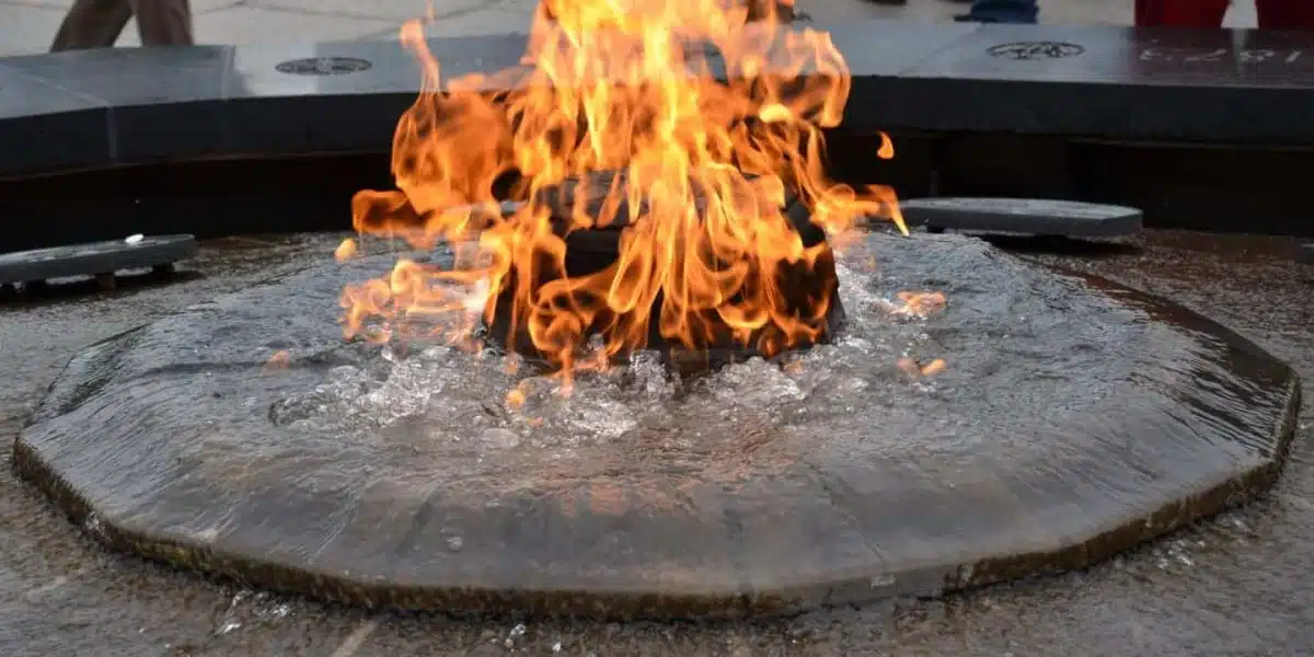 Fire pit circular con agua desbordante alrededor de la llama